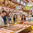 Load image into Gallery viewer, Vancouver Foodie Tours guests enjoying a tasting by the water on Granville Island
