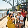 Load image into Gallery viewer, Vancouver Foodie Tours guests tasting food on Granville Island
