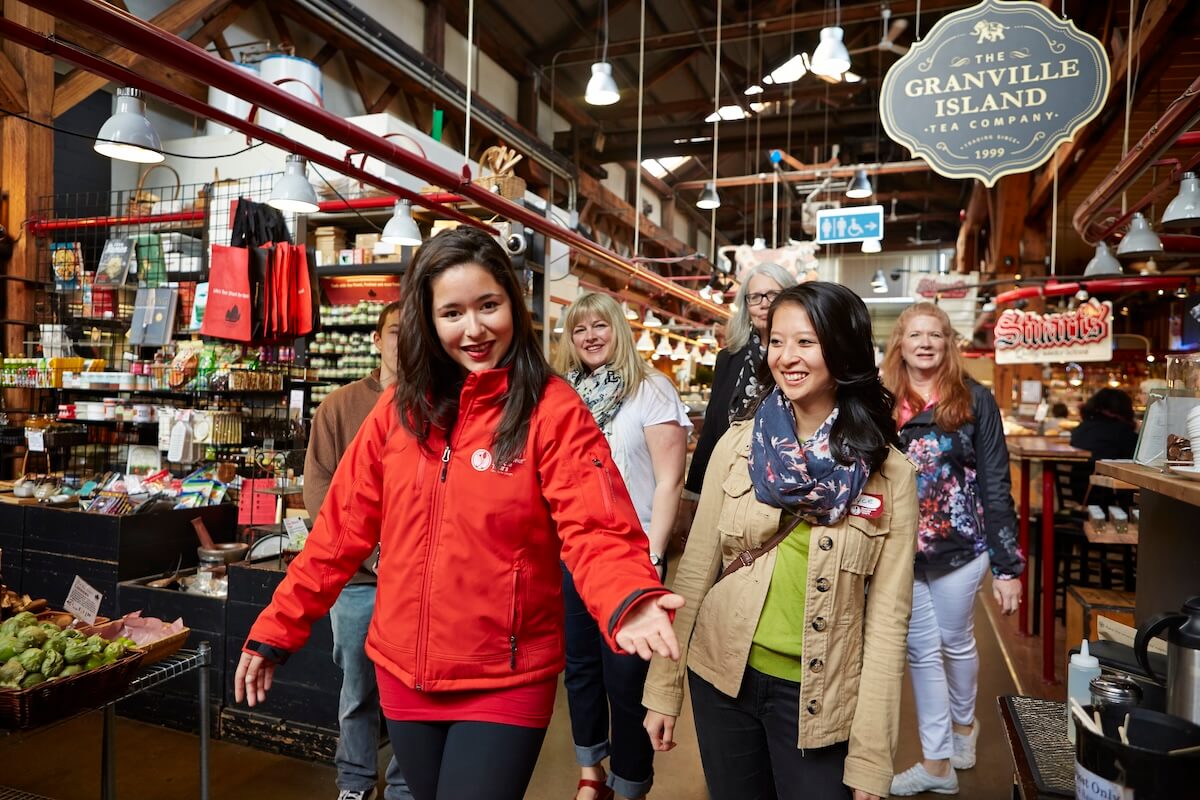 Vancouver Foodie Tours guide leading a group through Granville Island Public Market