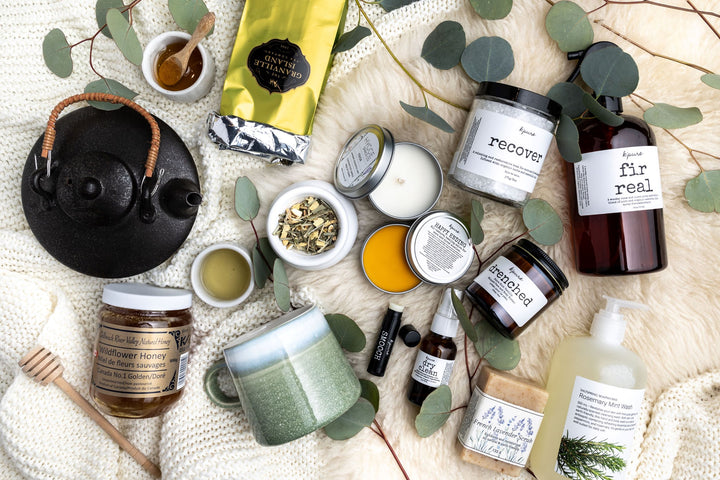 Local gift basket contents are laid out including granville island tea, k'pure bath products, local honey, french lavender soap from Cascadia and more